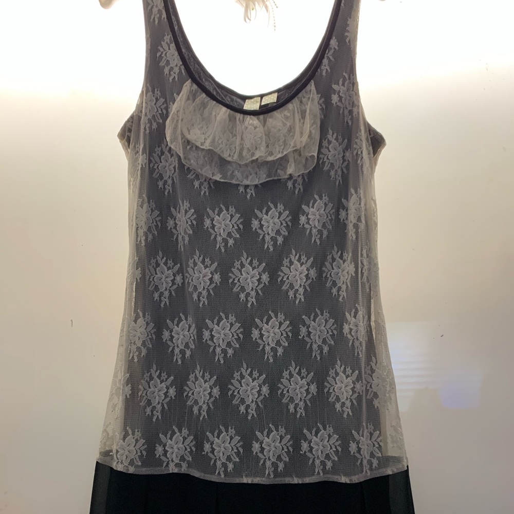 Pretty ivory lace detail dress length…26 inches. Made in Indonesia